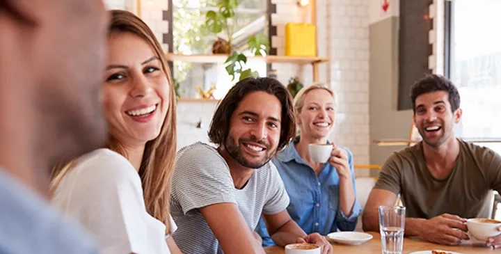 Group of people talking in a coffee shop