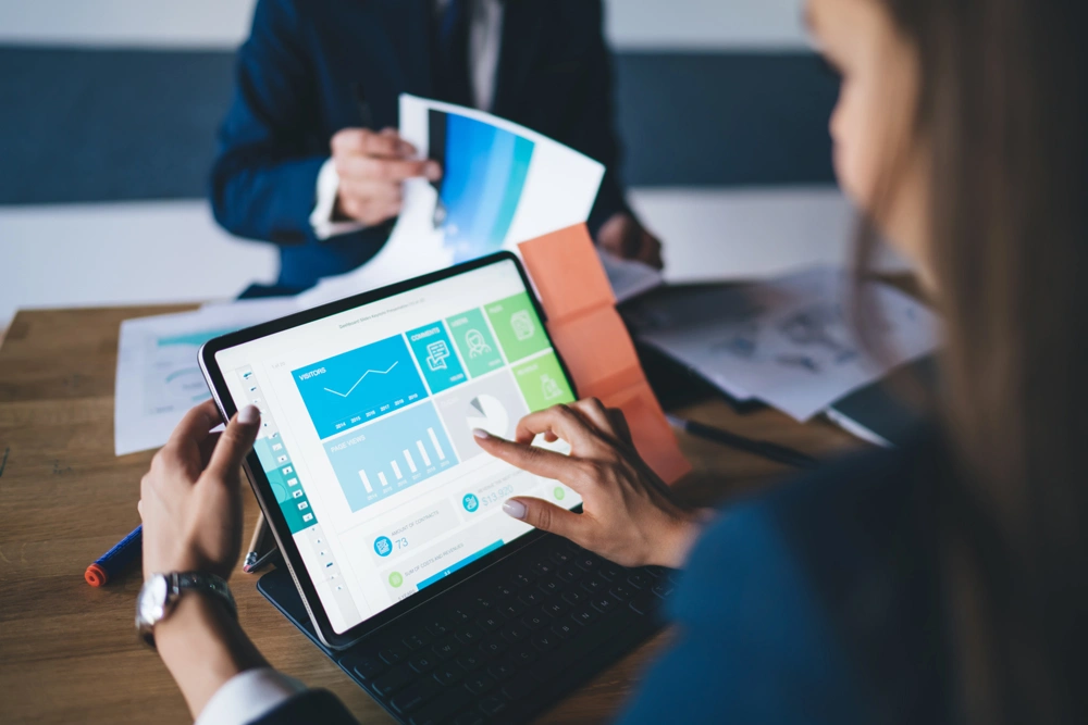 Cropped image of female professional checking financial website with revenue statistics and marketing infographics