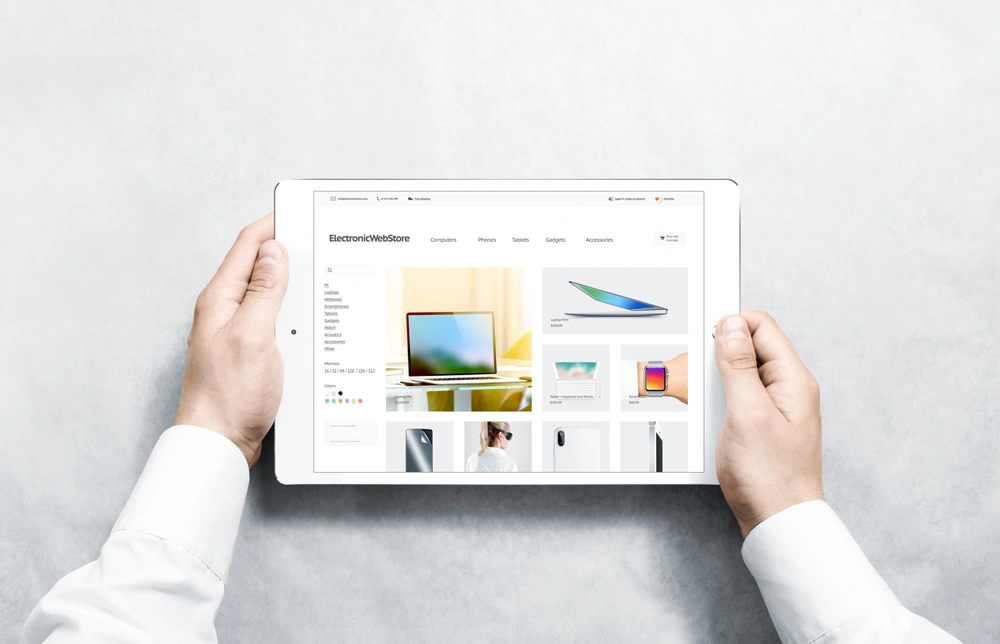 Hands holding tablet with electronic webstore mock up on screen